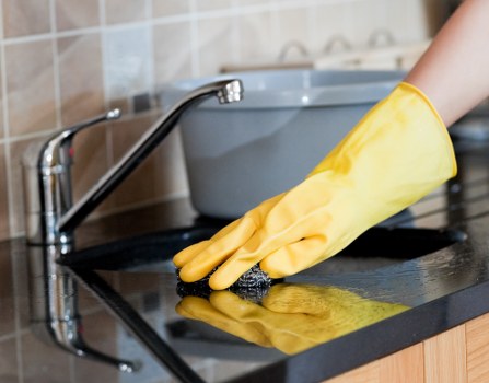Professional steam carpet cleaning removing dirt from a living room carpet